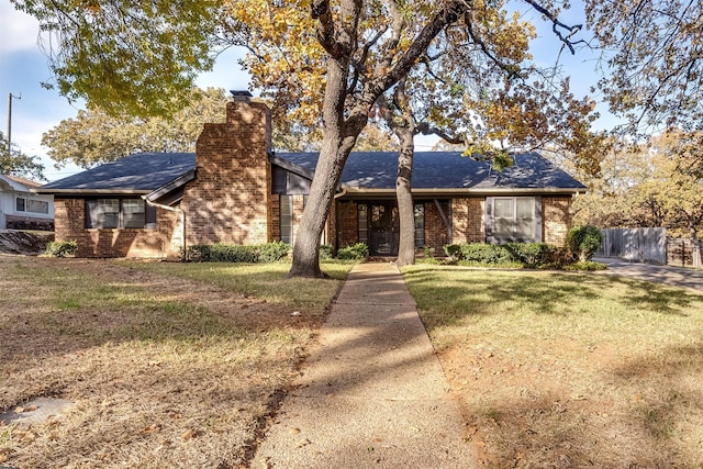 ranch-style home with a front lawn