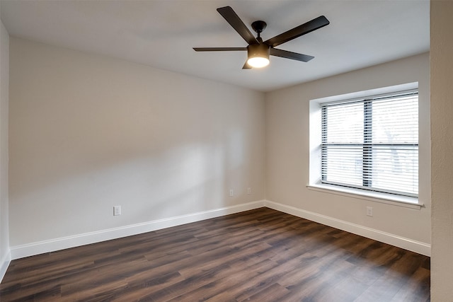 empty room featuring ceiling fan and dark hardwood / wood-style floors