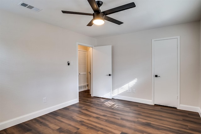 unfurnished room featuring dark hardwood / wood-style flooring and ceiling fan