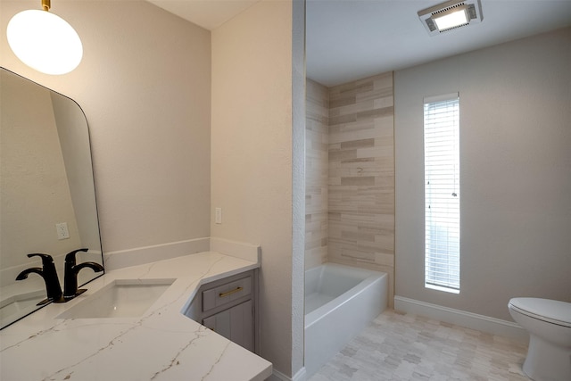 bathroom featuring vanity and toilet