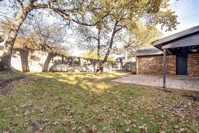 view of yard with a patio area and ceiling fan