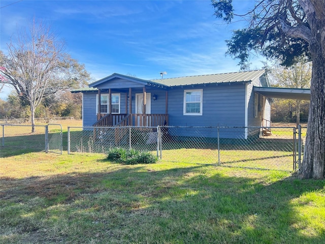 view of front of home with a front lawn and a carport