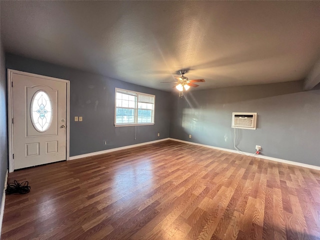 entryway featuring hardwood / wood-style flooring, ceiling fan, and a wall mounted air conditioner