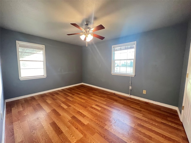 spare room featuring hardwood / wood-style flooring and ceiling fan