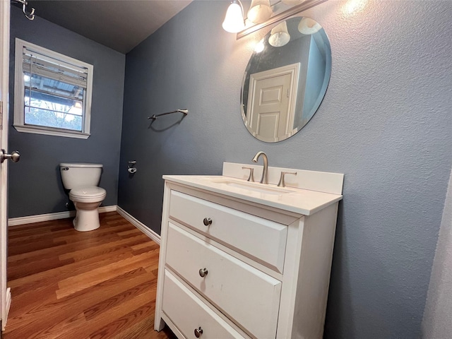 bathroom with vanity, hardwood / wood-style floors, and toilet