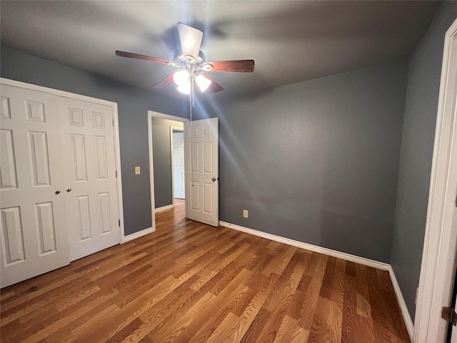 unfurnished bedroom with hardwood / wood-style floors and ceiling fan