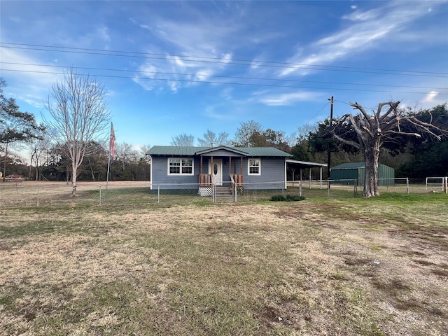 ranch-style home featuring a carport and a front lawn