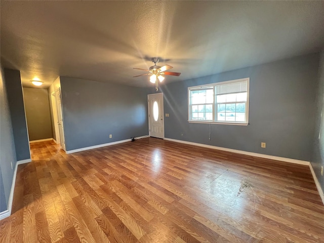 spare room with hardwood / wood-style flooring and ceiling fan