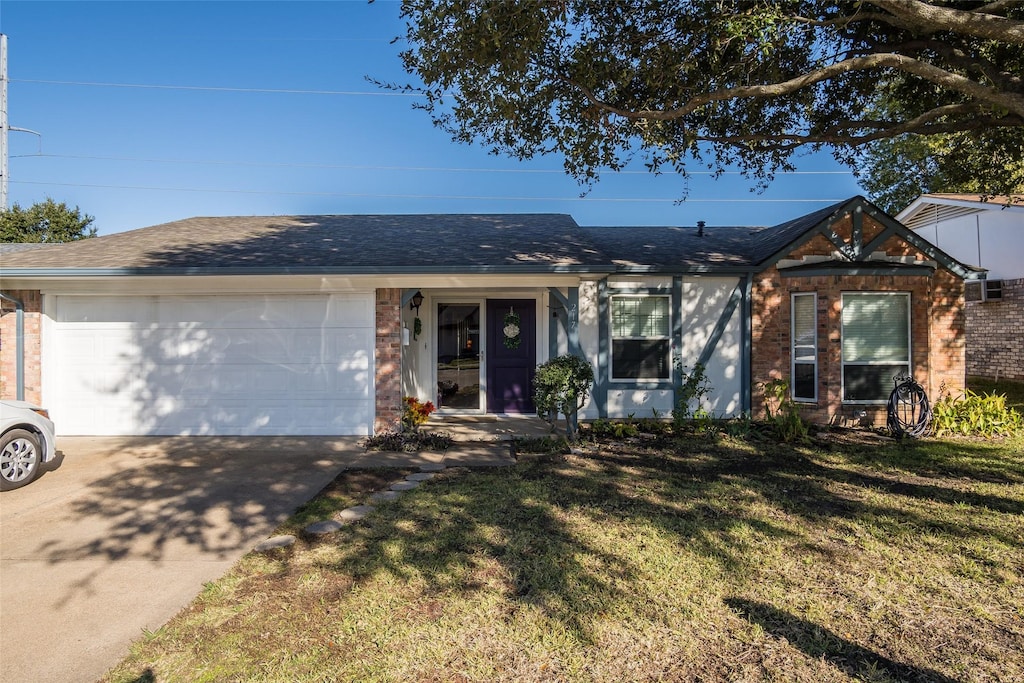 ranch-style house featuring a garage and a front yard