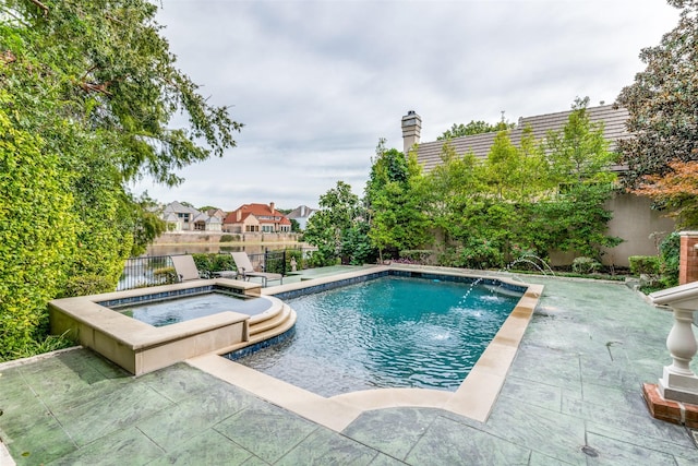 view of swimming pool with an in ground hot tub and pool water feature