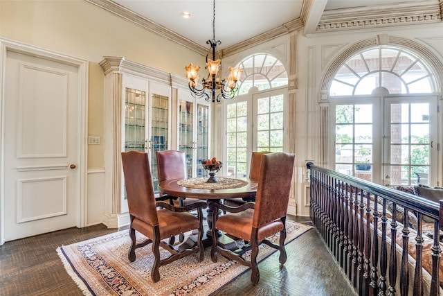 dining room featuring crown molding, a wealth of natural light, and a chandelier