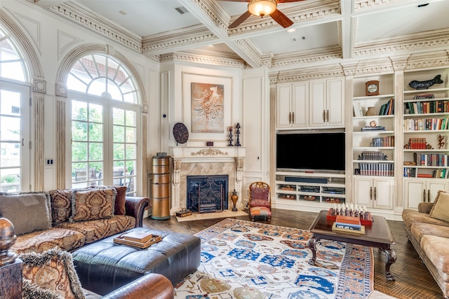 living room with built in shelves, coffered ceiling, beam ceiling, crown molding, and a premium fireplace