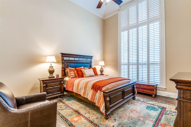 bedroom featuring hardwood / wood-style flooring, ornamental molding, and ceiling fan