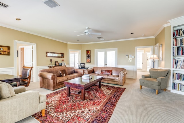 living room with crown molding, light colored carpet, and french doors