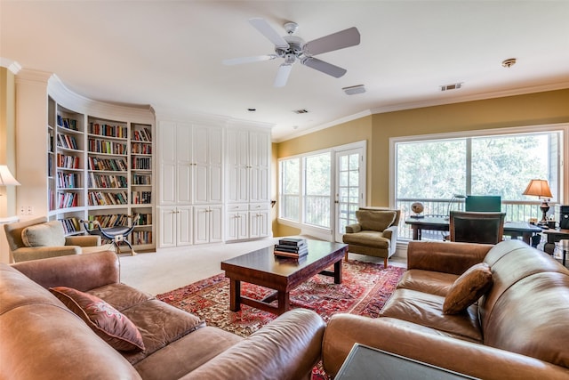 carpeted living room with ornamental molding and ceiling fan