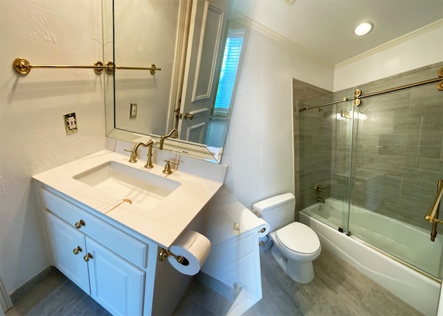 full bathroom featuring bath / shower combo with glass door, hardwood / wood-style floors, vanity, and toilet