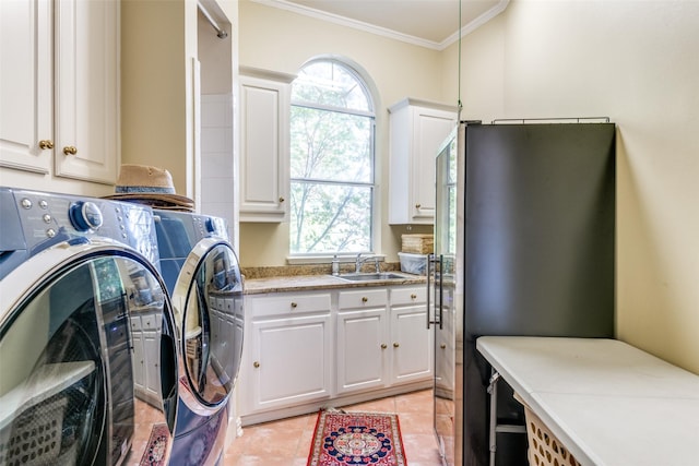 washroom with sink, cabinets, ornamental molding, plenty of natural light, and washer and clothes dryer