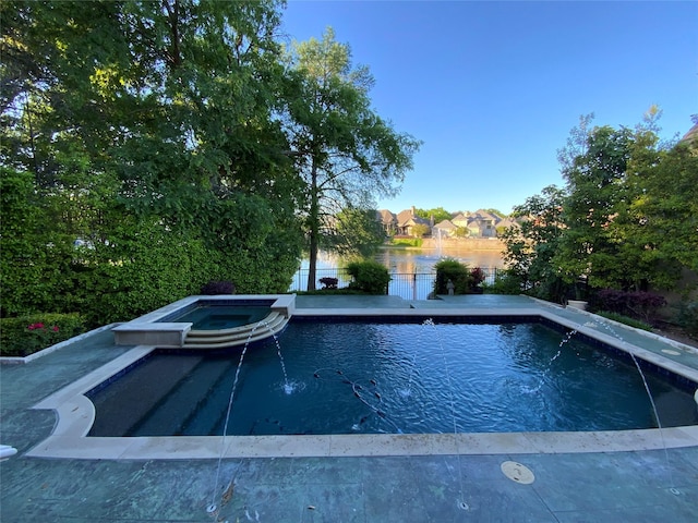 view of swimming pool with an in ground hot tub and a water view