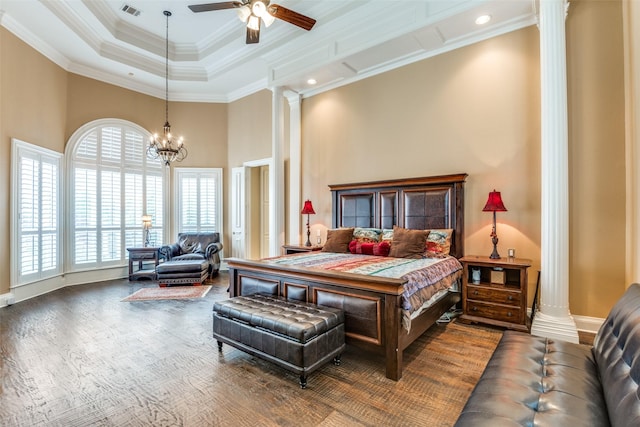 bedroom with ornate columns, crown molding, a raised ceiling, and an inviting chandelier