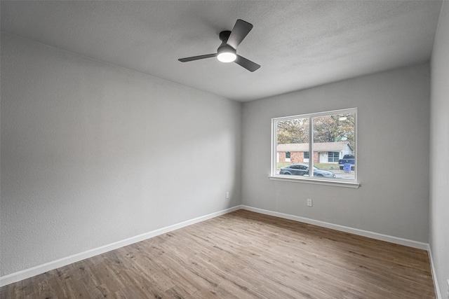 spare room featuring ceiling fan and hardwood / wood-style floors