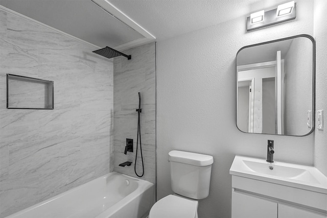 full bathroom featuring toilet, vanity, a textured ceiling, and tiled shower / bath