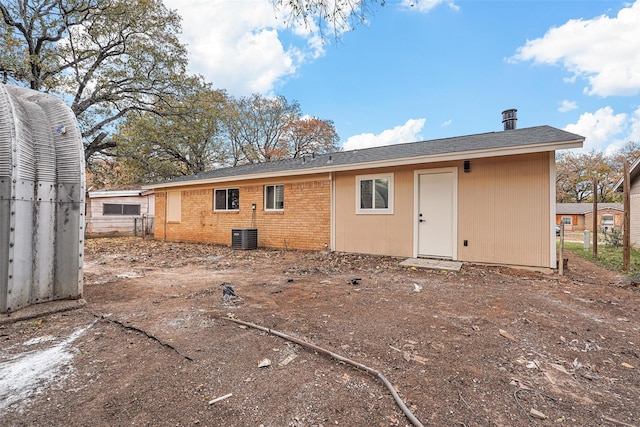 rear view of property with central AC unit