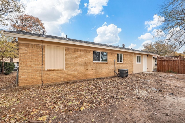 back of house with central AC unit