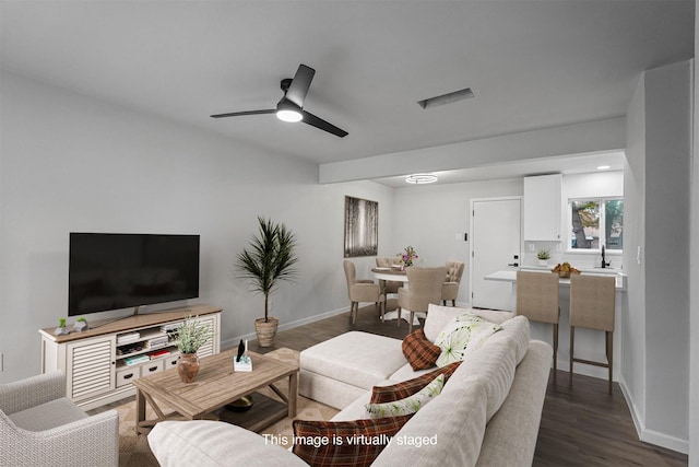 living room with ceiling fan, sink, and dark hardwood / wood-style floors