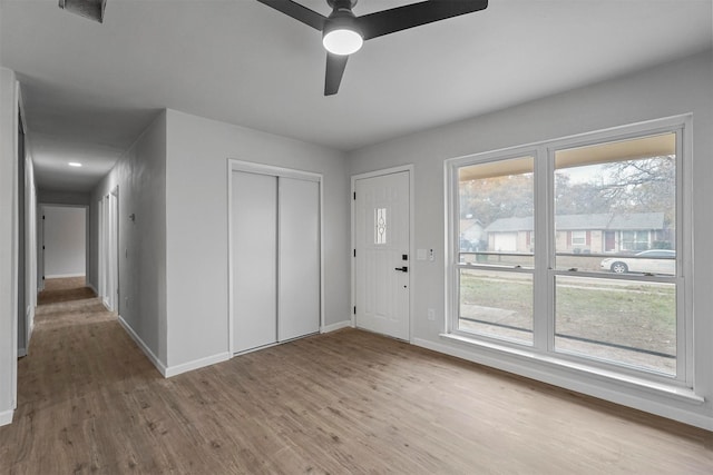 entryway featuring light wood-type flooring and ceiling fan