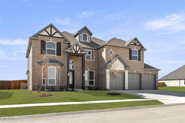 view of front of house featuring cooling unit, a garage, and a front lawn