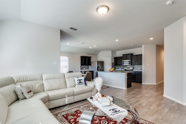 living room with wood-type flooring and lofted ceiling