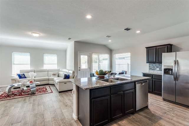 kitchen featuring appliances with stainless steel finishes, an island with sink, plenty of natural light, and sink