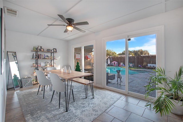 dining space with light tile patterned floors and ceiling fan