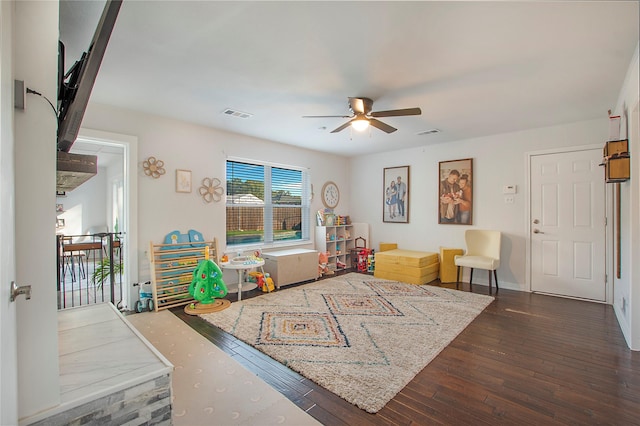 interior space with dark wood-type flooring and ceiling fan