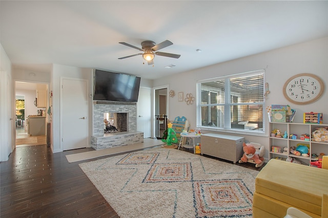 living room with ceiling fan and dark hardwood / wood-style flooring