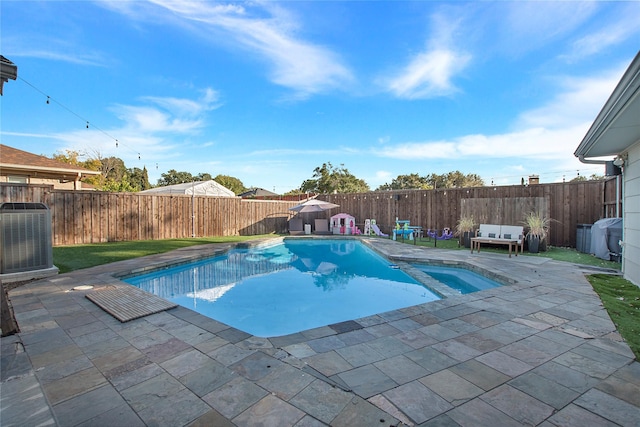 view of swimming pool with a patio and central AC unit