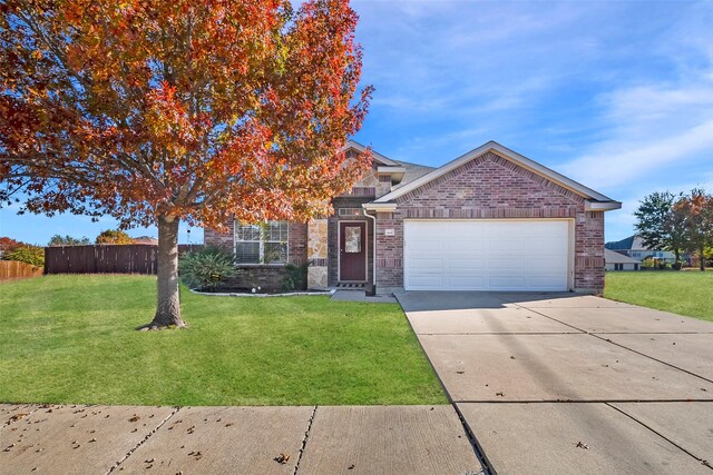 view of front of house with a front yard and a garage