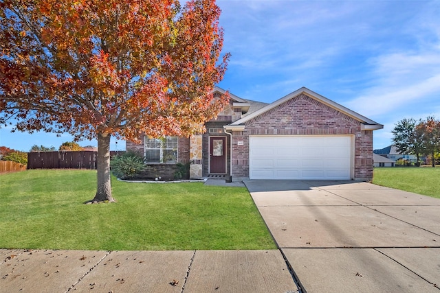 view of front of house with a garage, driveway, fence, a front yard, and brick siding