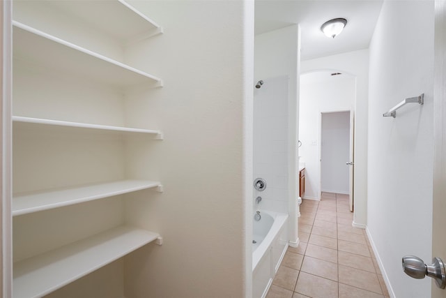 interior space featuring shower / bathtub combination, tile patterned flooring, baseboards, and vanity