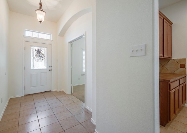 15646 Gatehouse Dr, Fort Worth, TX 76262 - foyer entrance with arched walkways, light tile patterned flooring, and baseboards