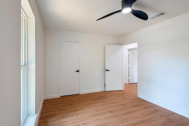 unfurnished bedroom with ceiling fan and light hardwood / wood-style flooring