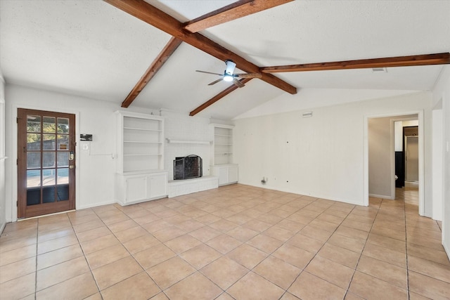 unfurnished living room featuring vaulted ceiling with beams, light tile patterned floors, a brick fireplace, and a textured ceiling