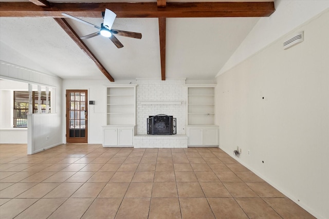 unfurnished living room with ceiling fan, lofted ceiling with beams, a brick fireplace, and light tile patterned floors