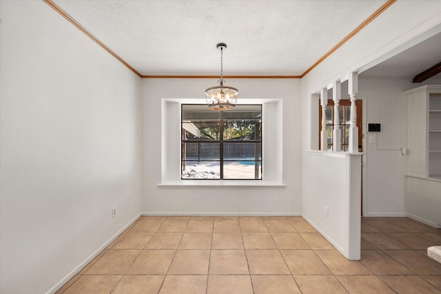 unfurnished dining area with a notable chandelier, ornamental molding, a textured ceiling, and light tile patterned floors