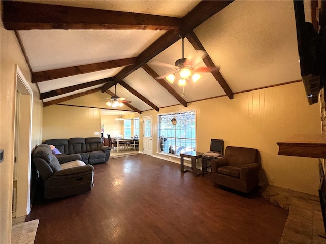 living room with vaulted ceiling with beams, ceiling fan, and dark hardwood / wood-style flooring