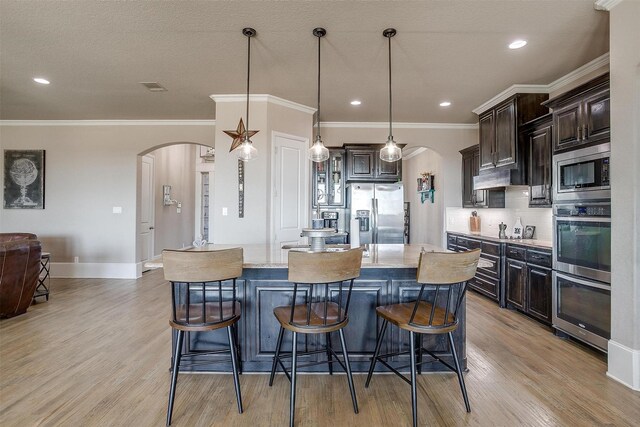 living room with a fireplace, ceiling fan, and light hardwood / wood-style flooring