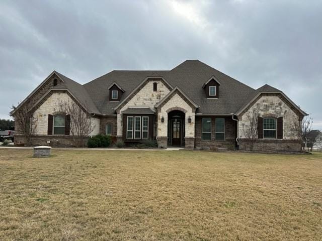 french country inspired facade with a front lawn