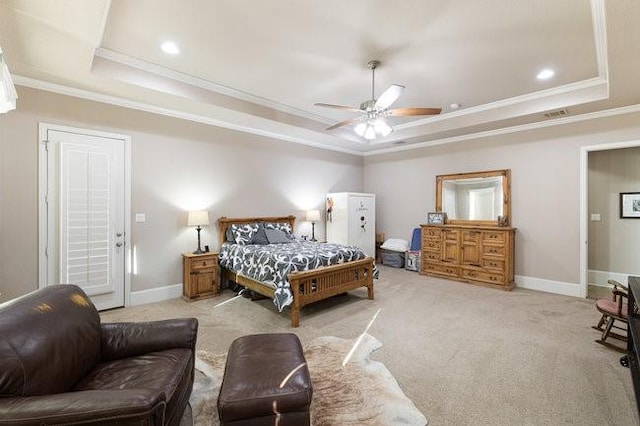 bedroom with ornamental molding, ceiling fan, a tray ceiling, and light carpet