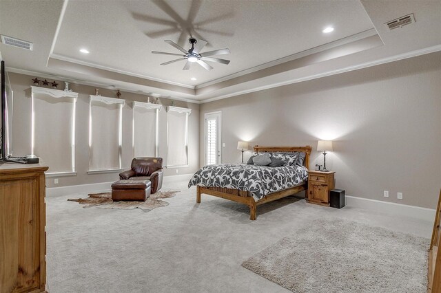 bedroom featuring visible vents, a raised ceiling, and light colored carpet