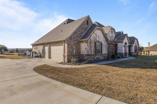 view of front of property with a garage and a front lawn